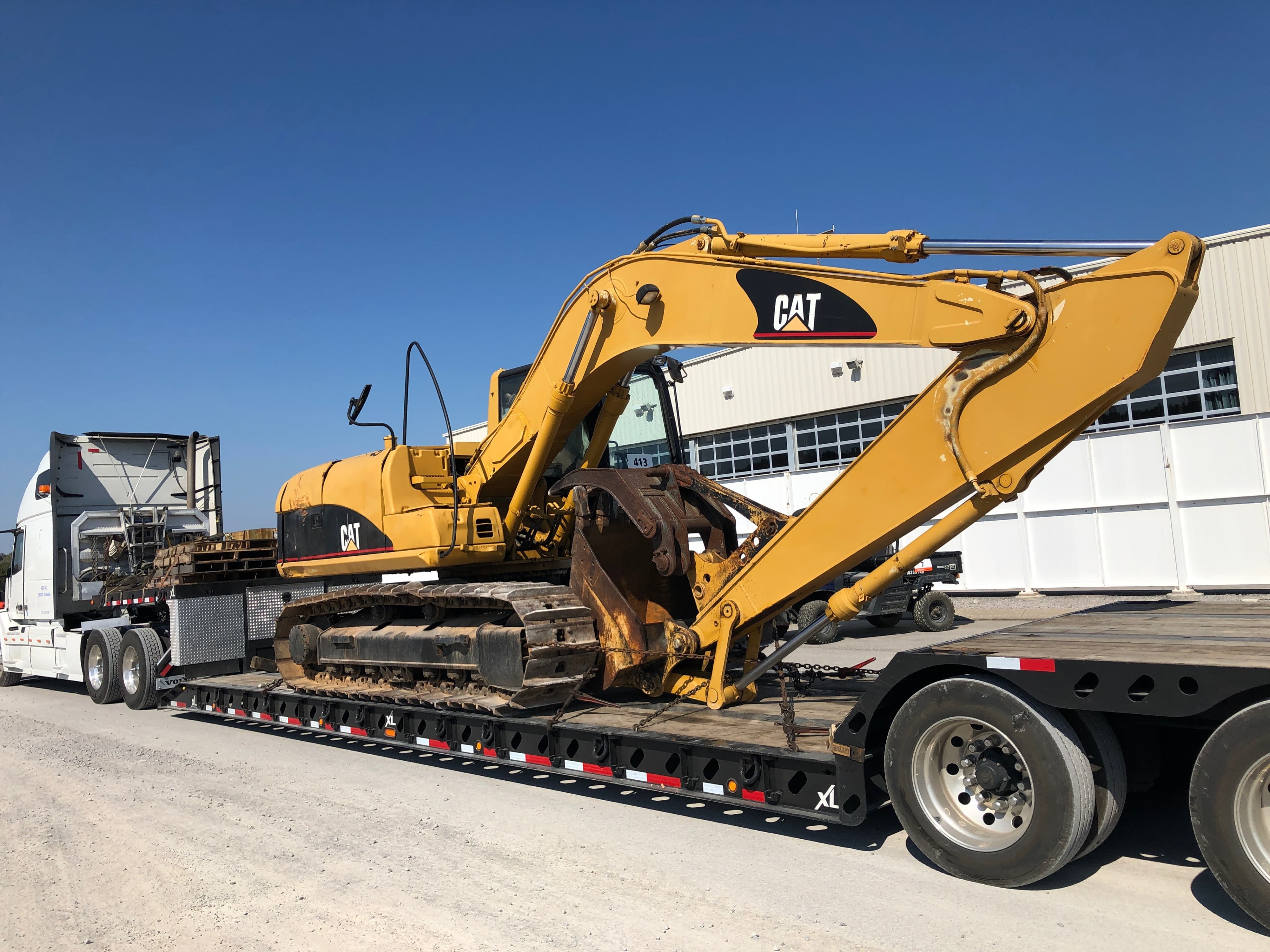 CAT 315CL excavator on a lowboy trailer