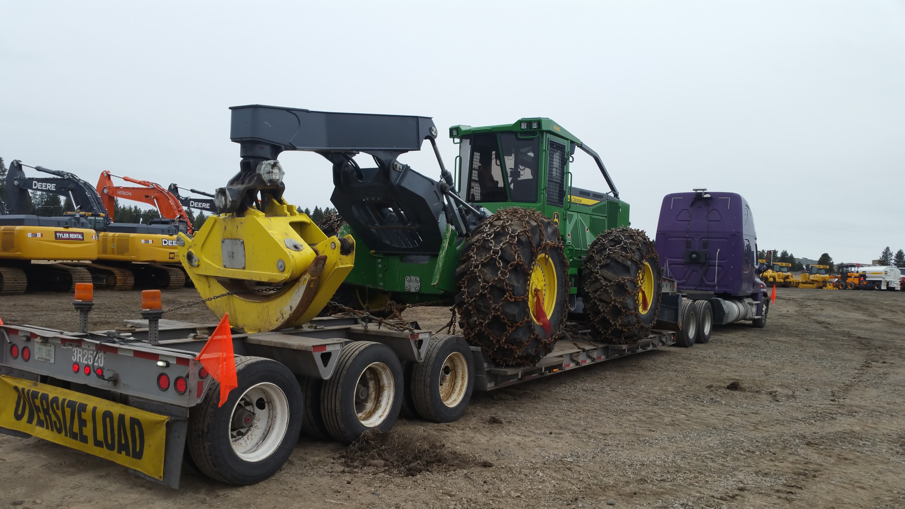Lowboy trailer transporting oversized equipment