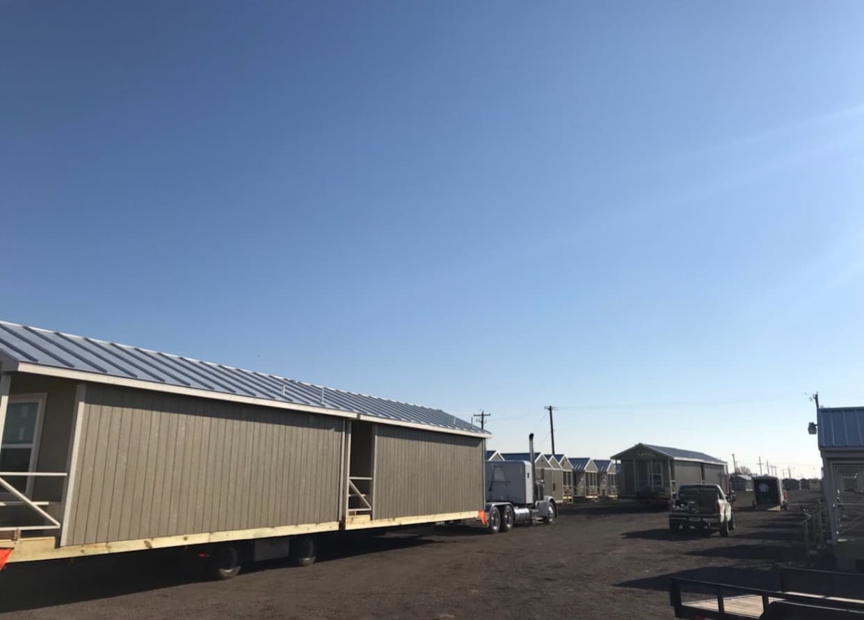 Cabin transport load secured on a trailer